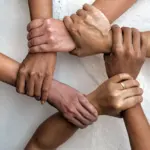 5 people holding hands in a ring