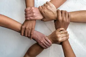 5 people holding hands in a ring